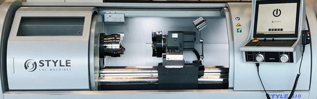 STYLE CNC lathe machine with an open chamber, showcasing the internal spindle and tooling area.