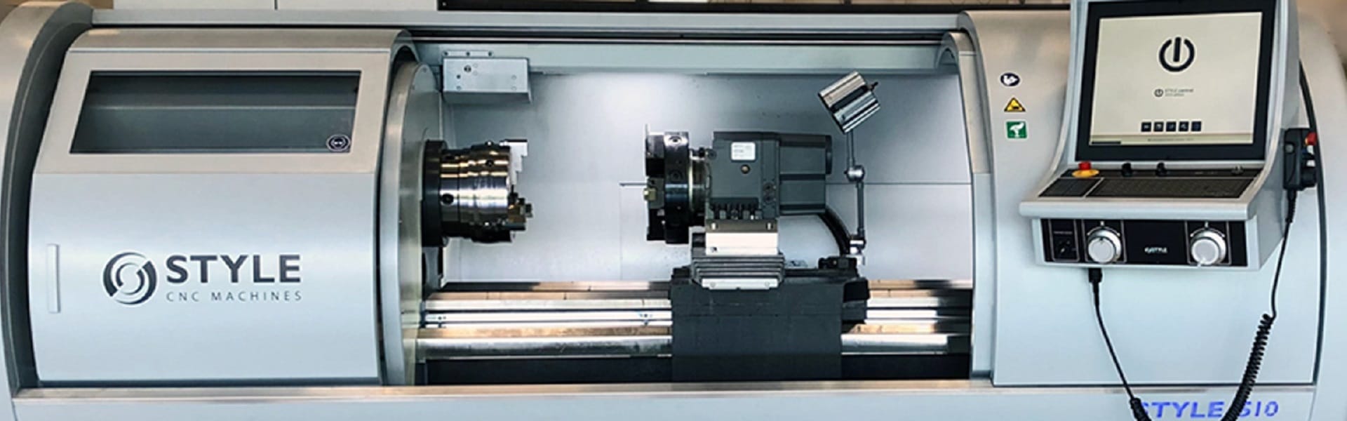 STYLE CNC lathe machine with an open chamber, showcasing the internal spindle and tooling area.